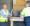 Two middle-aged men talking to each other. 